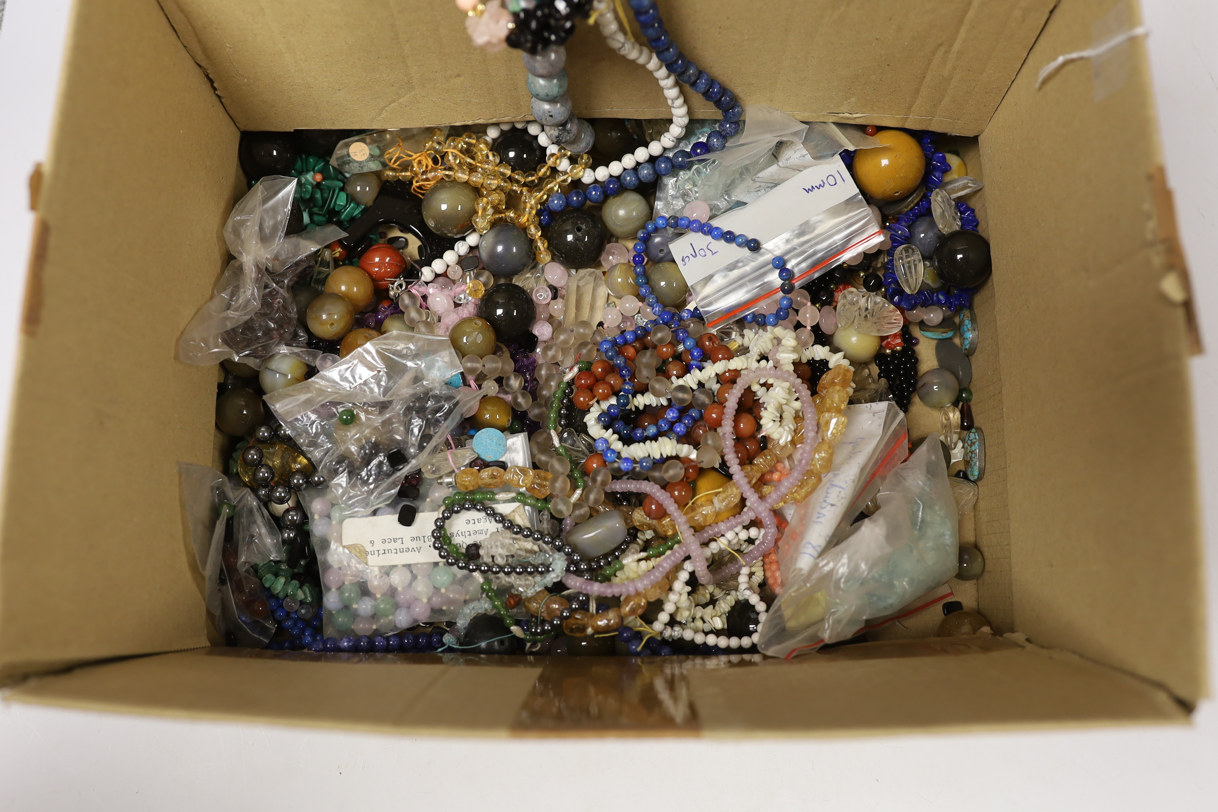 A large quantity of assorted costume jewellery and loose beads including agate.